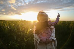 person holding child in field